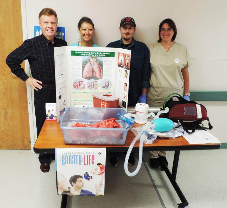 Director of Cardiopulmonary Services Sheridan Moosman (left) and SLV Health's team of Respiratory Therapists stand by the display they created for National Respiratory Care Week.