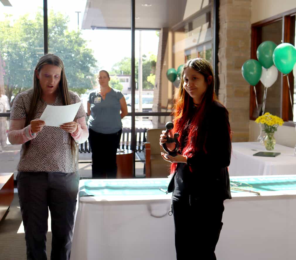 Amy Oaks shares the story of the Daisy Award with the crowd gathered for Lilliana Chavez's celebration. 