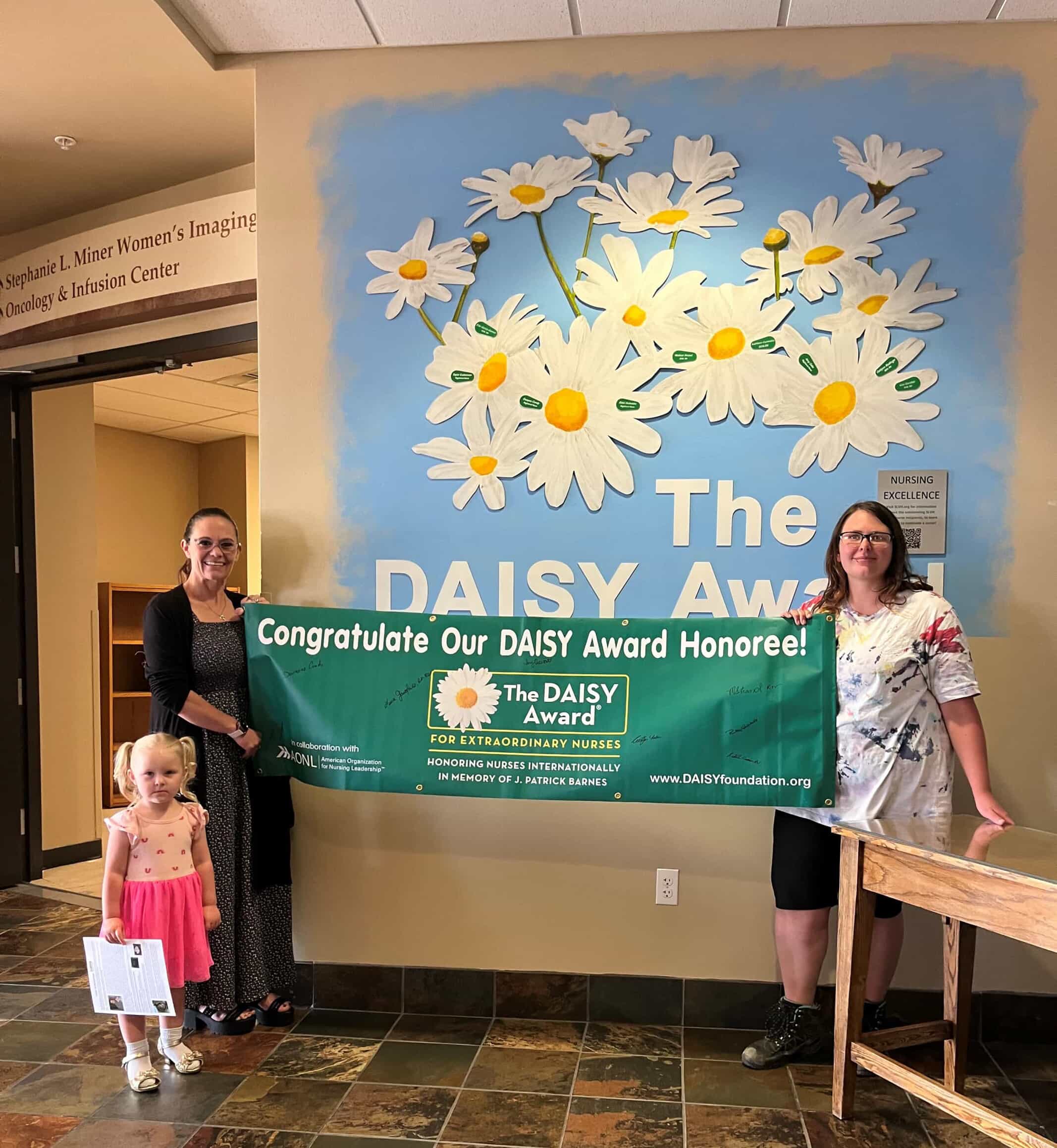 Caitlynn Radliner and Malissa Strand with DAISY Banner