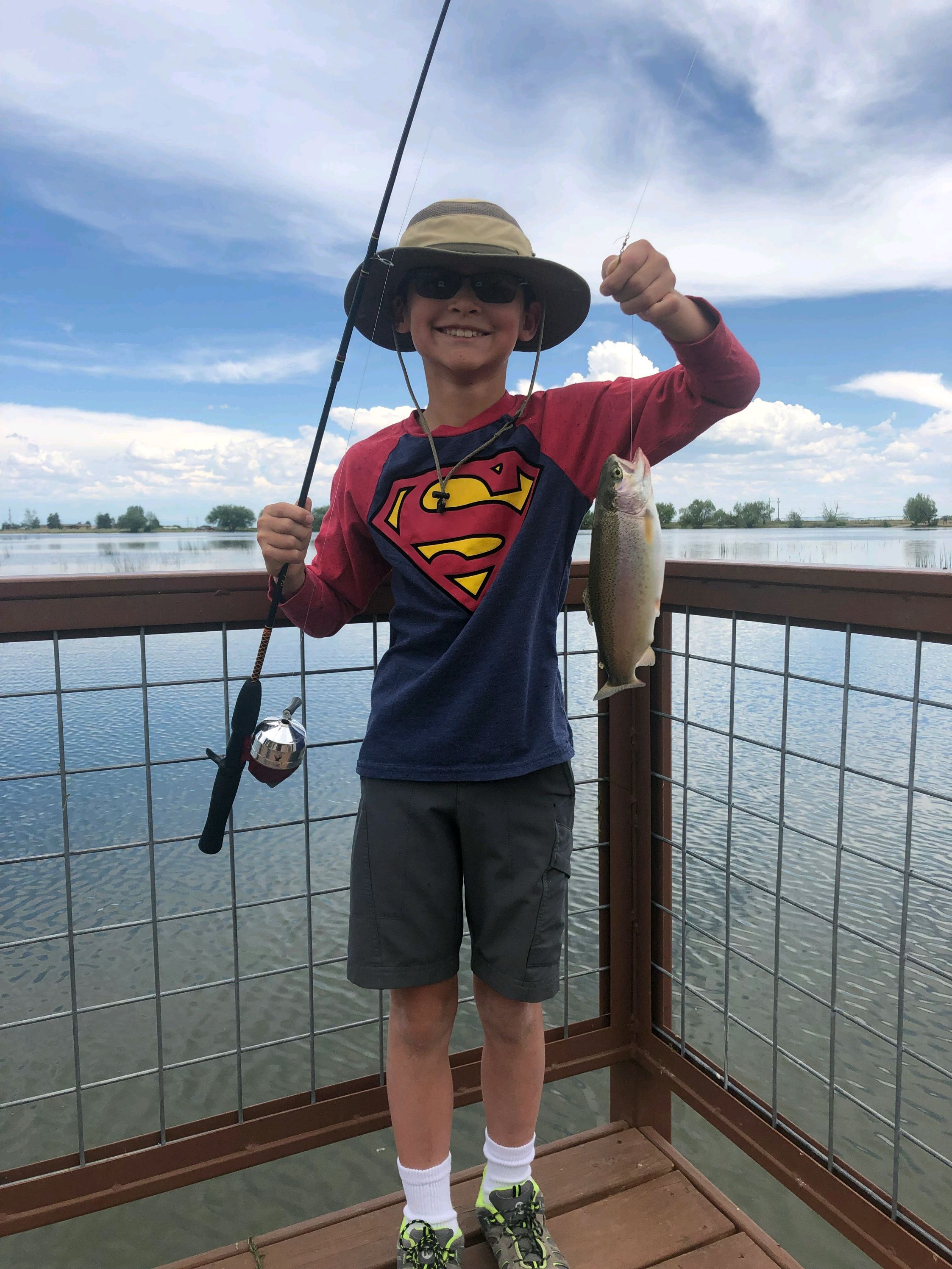 Voutsalath boy with fish wearing hat and sunglasses