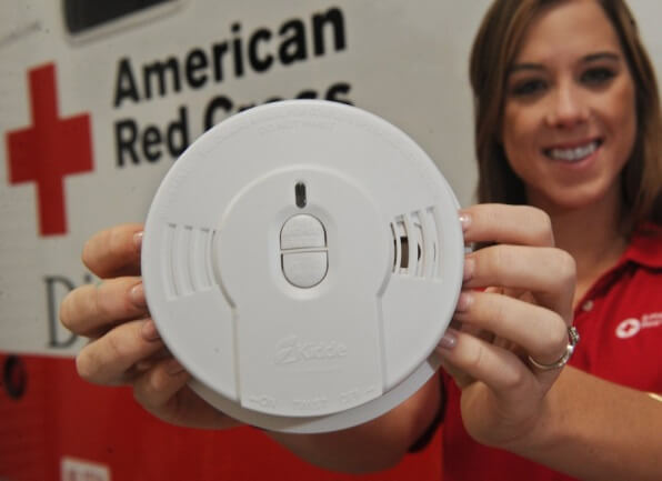 woman holding smoke alarm