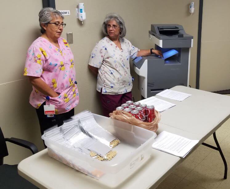 woman manning table with supplies