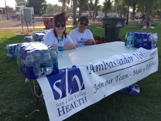 Two volunteers sitting at a table 