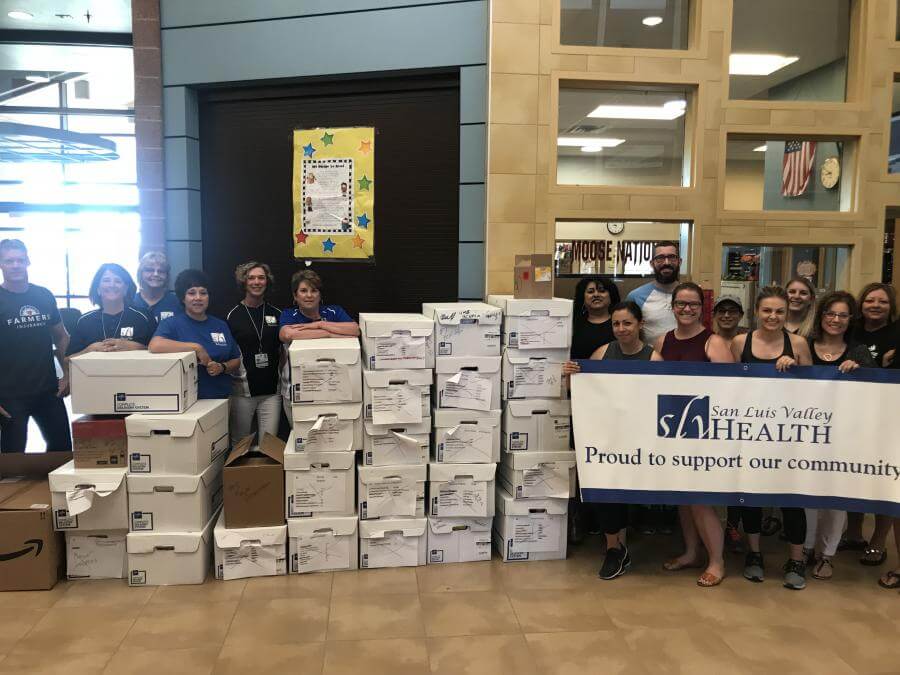 SLV Health delivers supplies to Alamosa K-5 teachers. Dylan Brown generously donated the use of his trailer for the delivery.