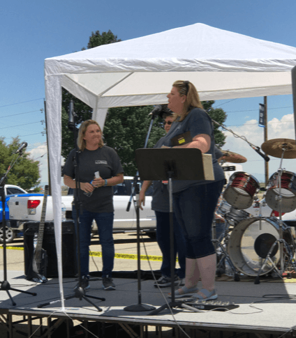 Michelle Gay, CCH Foundation Director and Kelly Gallegos, CCH Administrator on stage at the BBQ and Quilt Auction event