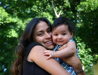 Youthful mother holding baby